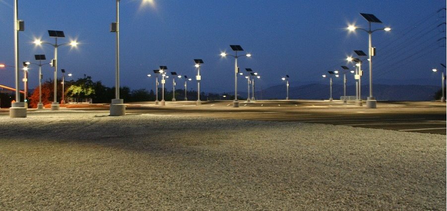 What is the importance of using solar lights for parking lots?